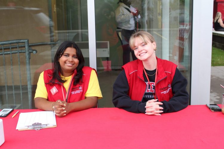 Two students smiling at the camera