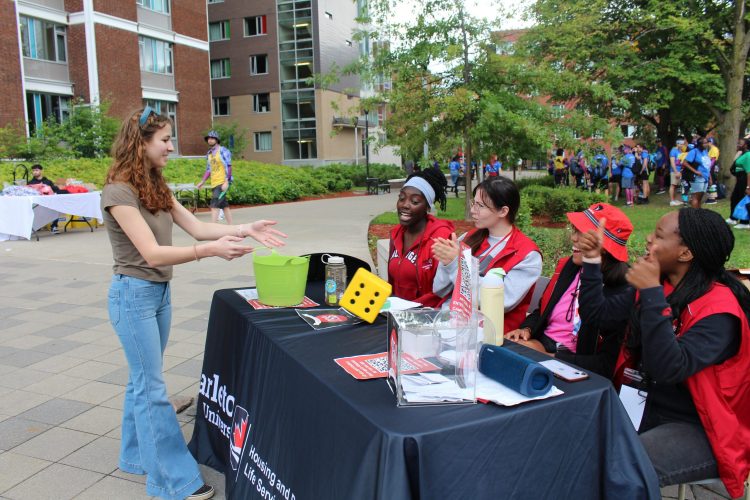 Four students interacting with a new student