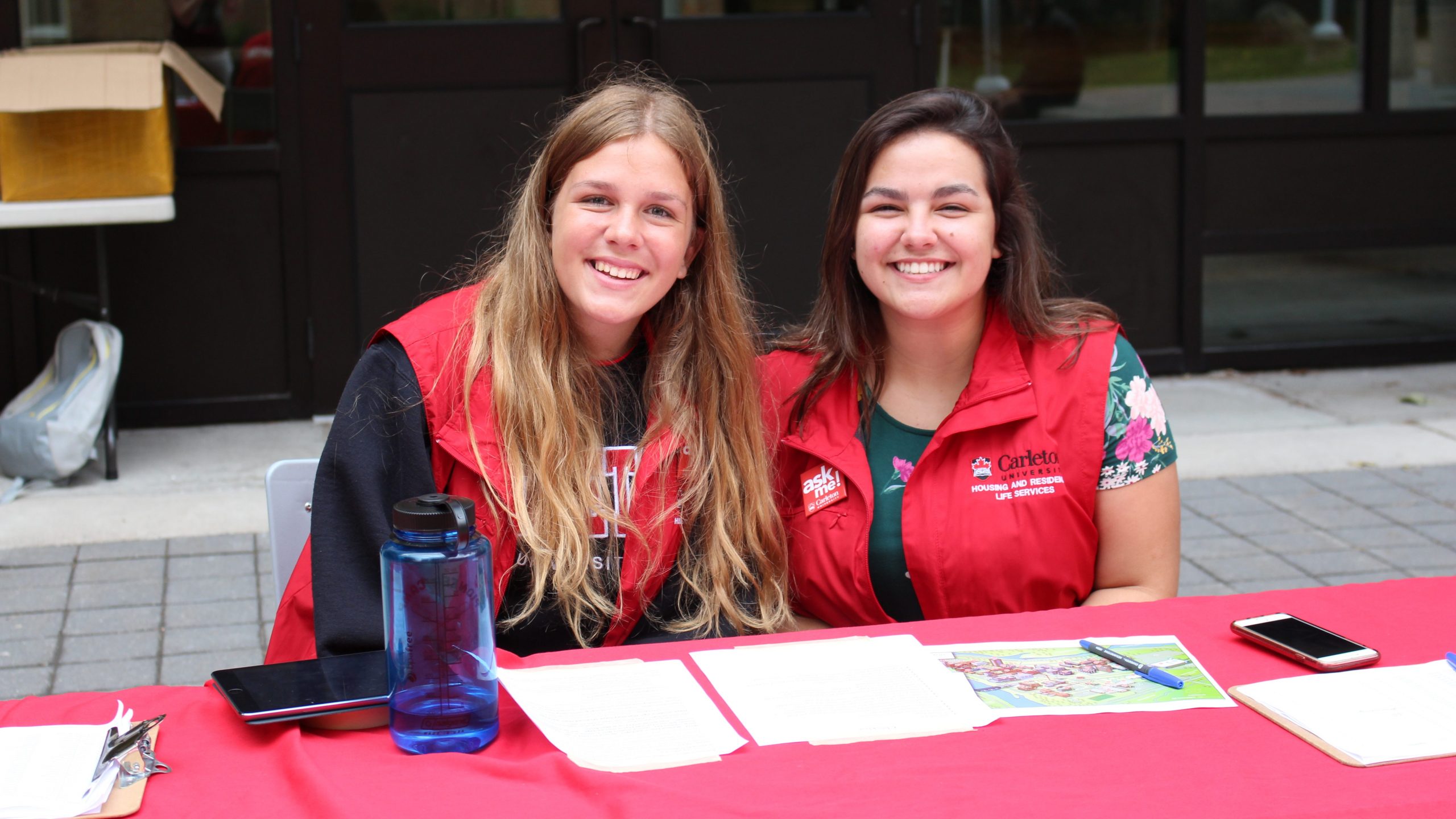 Two residence staff sit at a desk