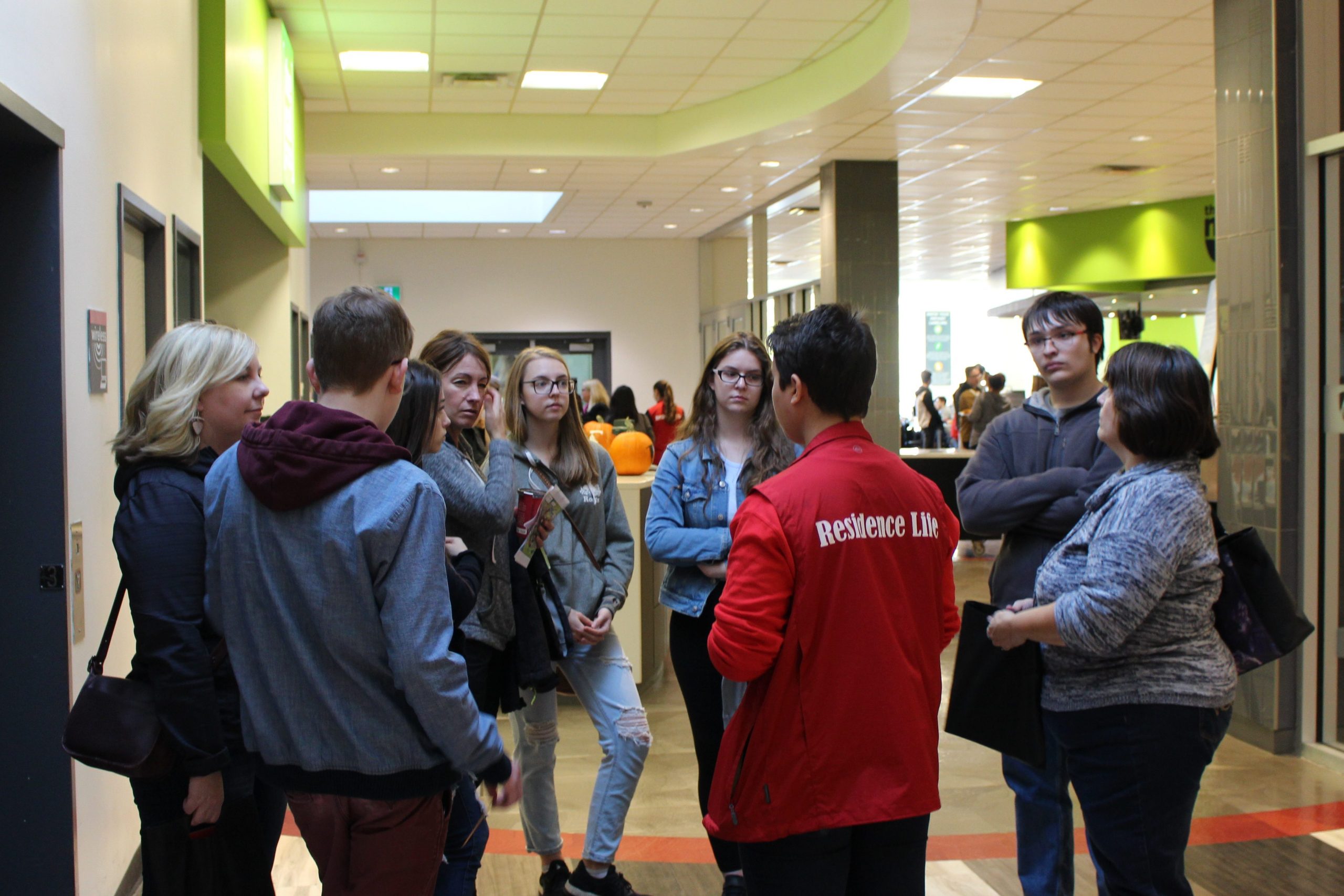 A tour group listens to a tour guide in the caf