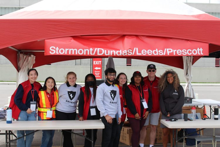 Team of student stand standing under the tent