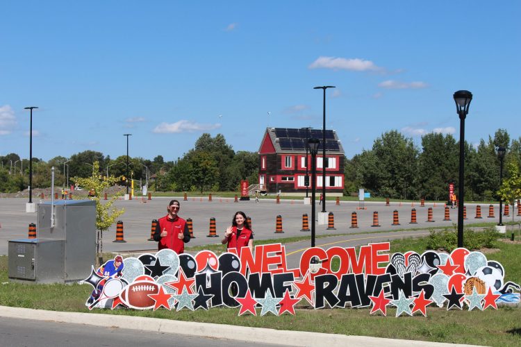 Students infront of the sign