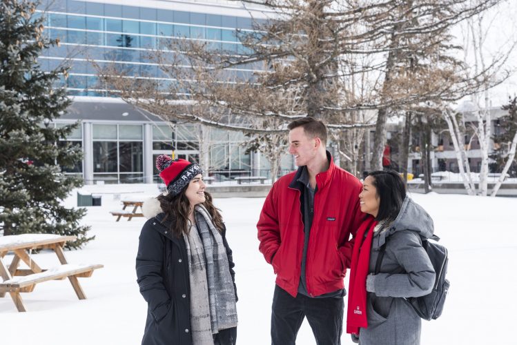 Three students in winter on Carleton campus