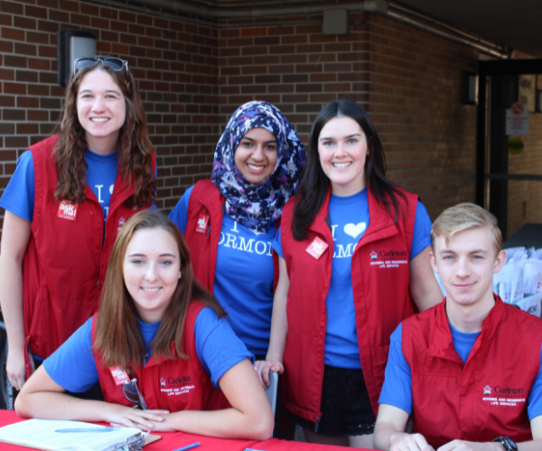 Five welcome staff pose for a photo