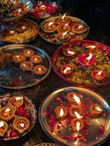 this is an image of various bowls that have lit diyas for Diwali celebration 